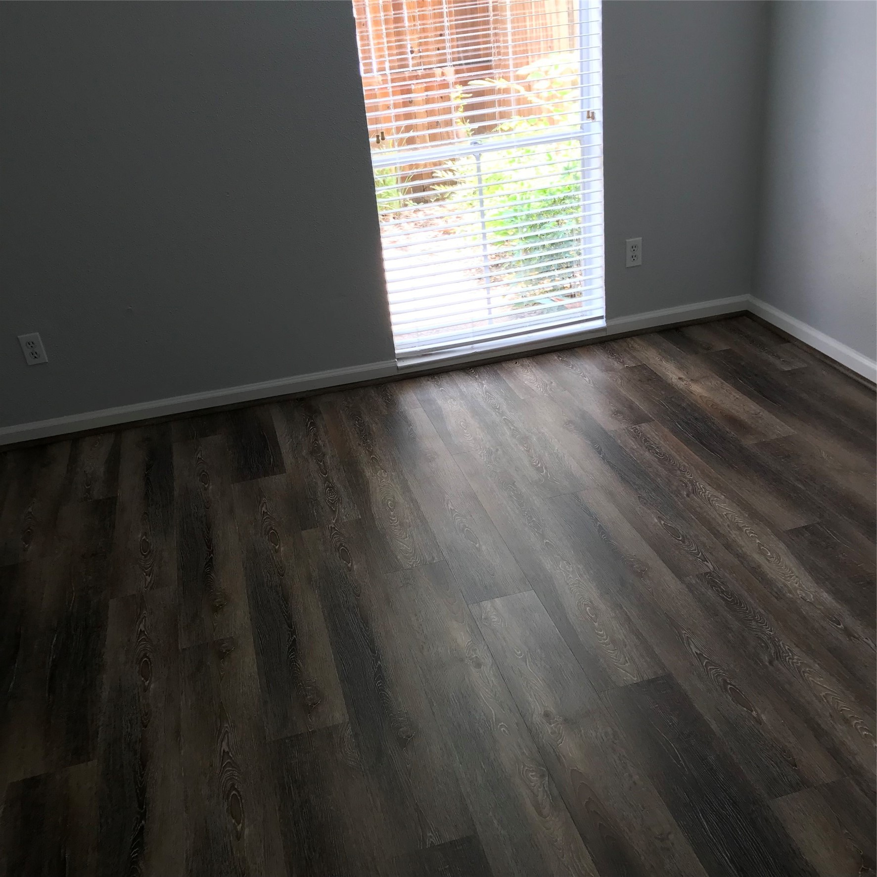 4631 Wild Indigo Street, Unit 560 Houston, TX 77027 - Photo 7 of 12 a view of an empty room with wooden floor and a window