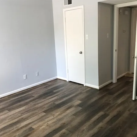 an empty room with wooden floor