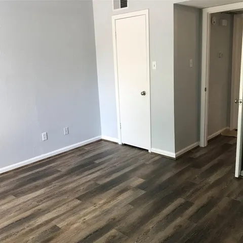 an empty room with wooden floor