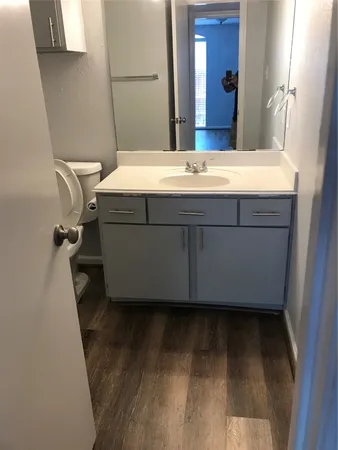 a room with a sink and a mirror