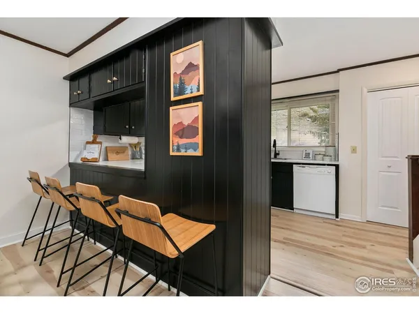 a kitchen with a sink window and cabinets
