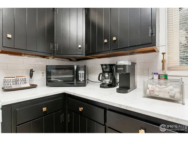 a kitchen with cabinets and wooden floor