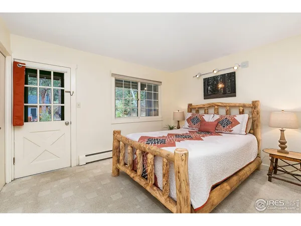 a bedroom with a bed table and a window