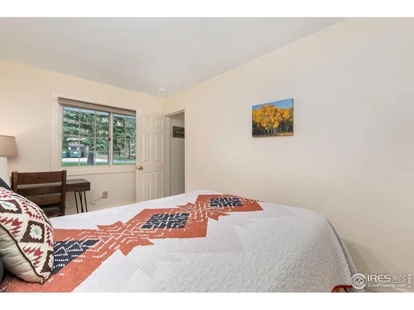 a bedroom with furniture and a large window