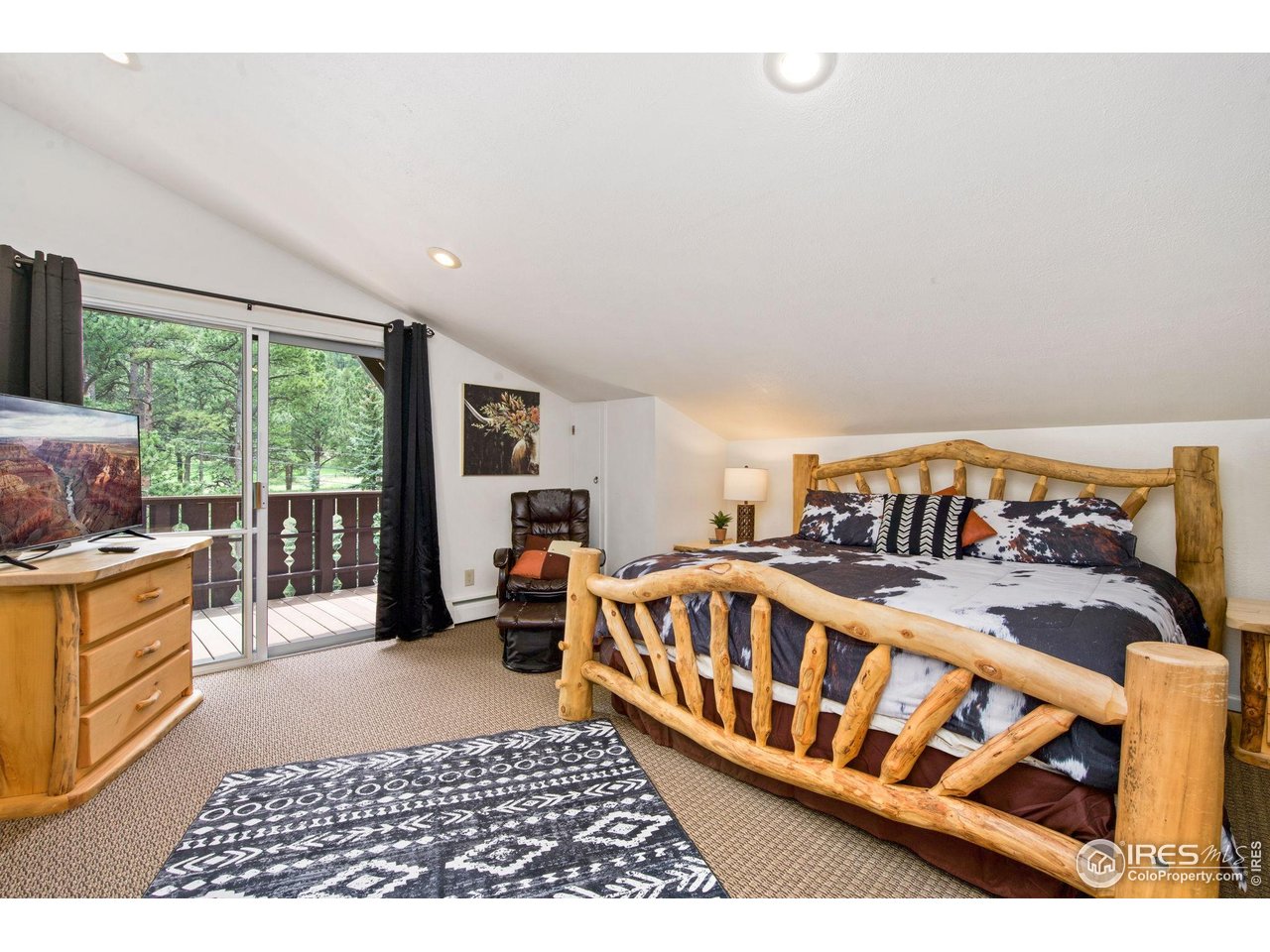 2760 Fall River Road, Unit 228 Estes Park, CO 80517 - Photo 21 of 37 Primary Bedroom with deck access!