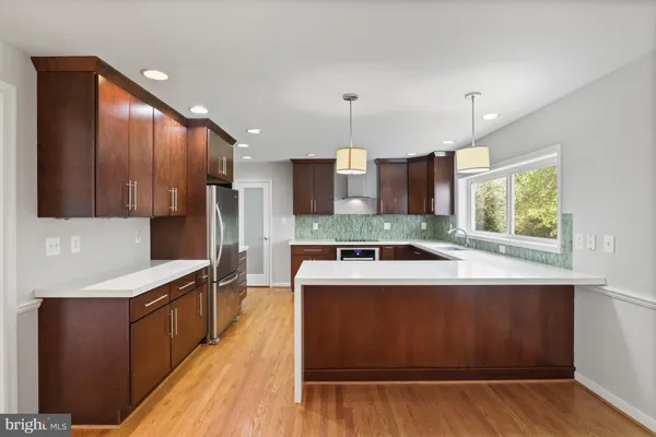 a kitchen with stainless steel appliances granite countertop wooden cabinets a stove top oven a sink and dishwasher