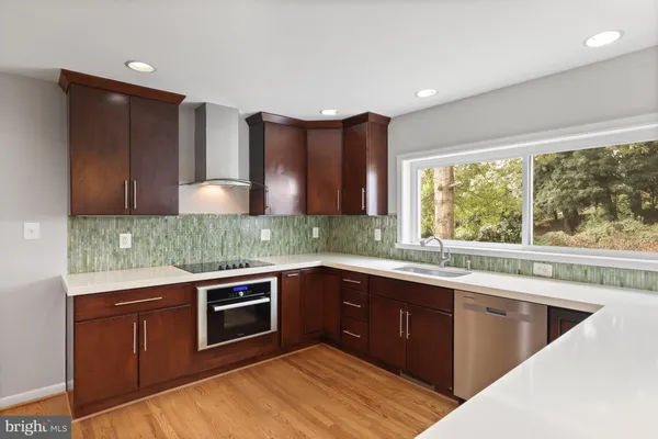 a kitchen with a sink stove and cabinets
