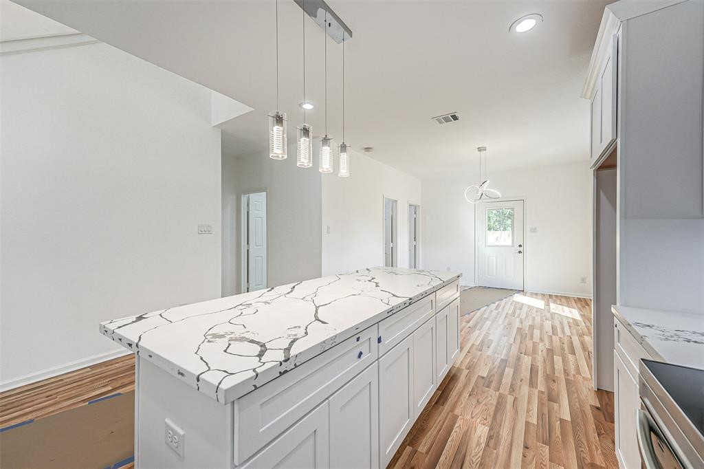5317 Chennault Road, Unit A Houston, TX 77033 - Photo 5 of 11 a spacious bathroom with a granite countertop sink a mirror and vanity