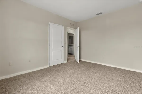 a view of an empty room and a window