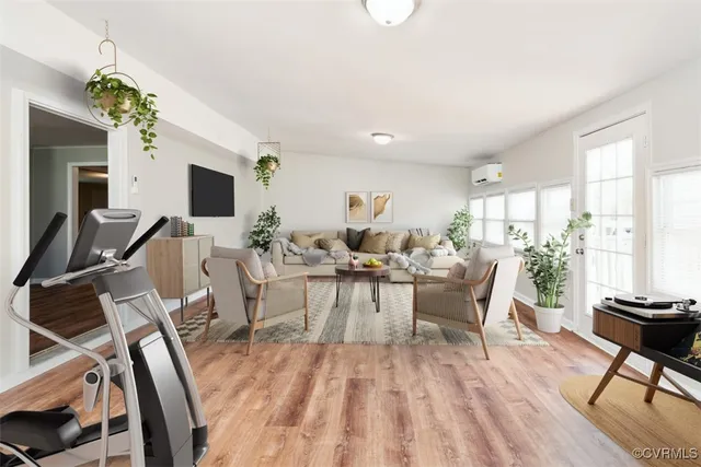 a living room with furniture a fireplace and a flat screen tv
