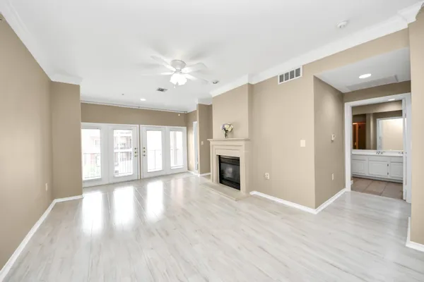 wooden floor in an empty room with a ceiling fan