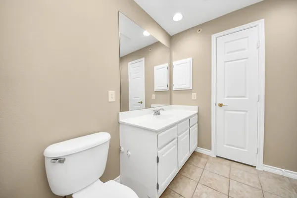 a bathroom with a sink a toilet and a mirror