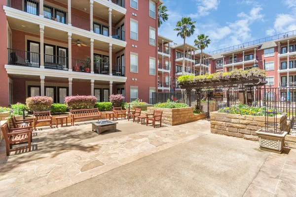a view of a patio with table and chairs potted plants