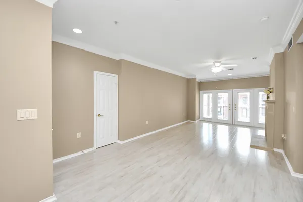 a view of a livingroom with a fireplace and chandelier fan