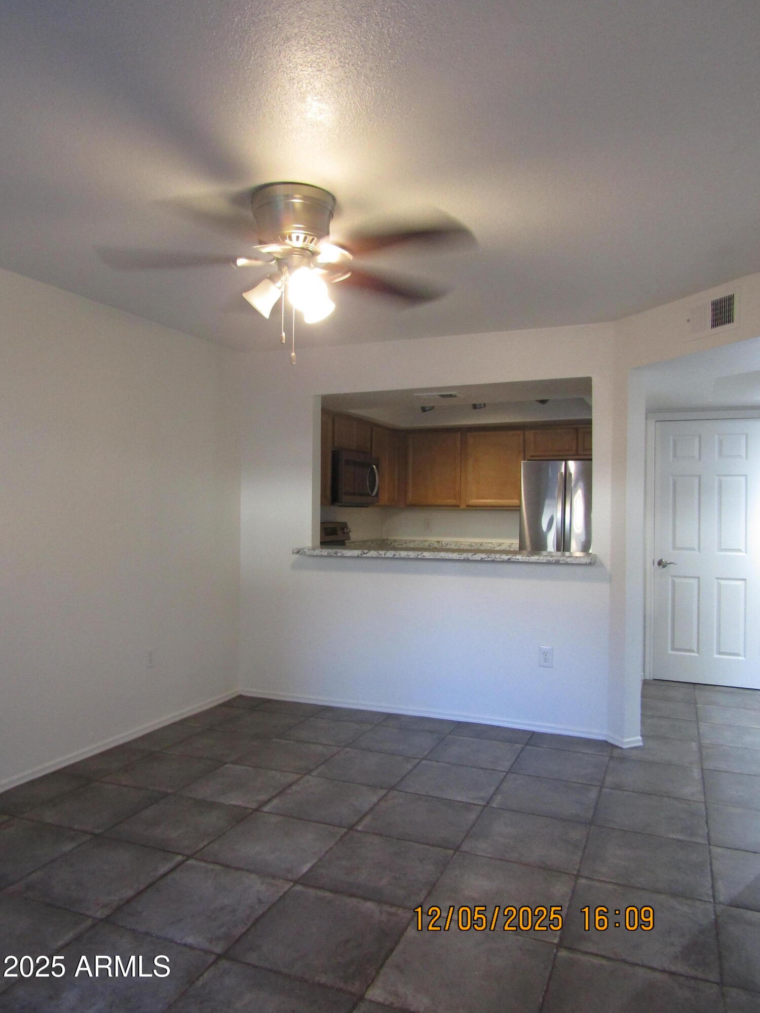 1331 West Baseline Road, Unit 102 Mesa, AZ 85202 - Photo 2 of 13 a view of a livingroom with a ceiling fan and window