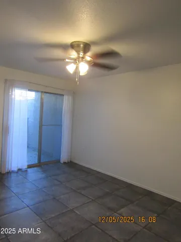 an empty room with a empty space and a ceiling fan