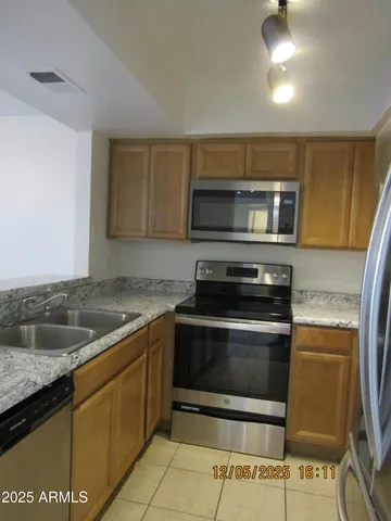 a kitchen with a sink and a stove top oven