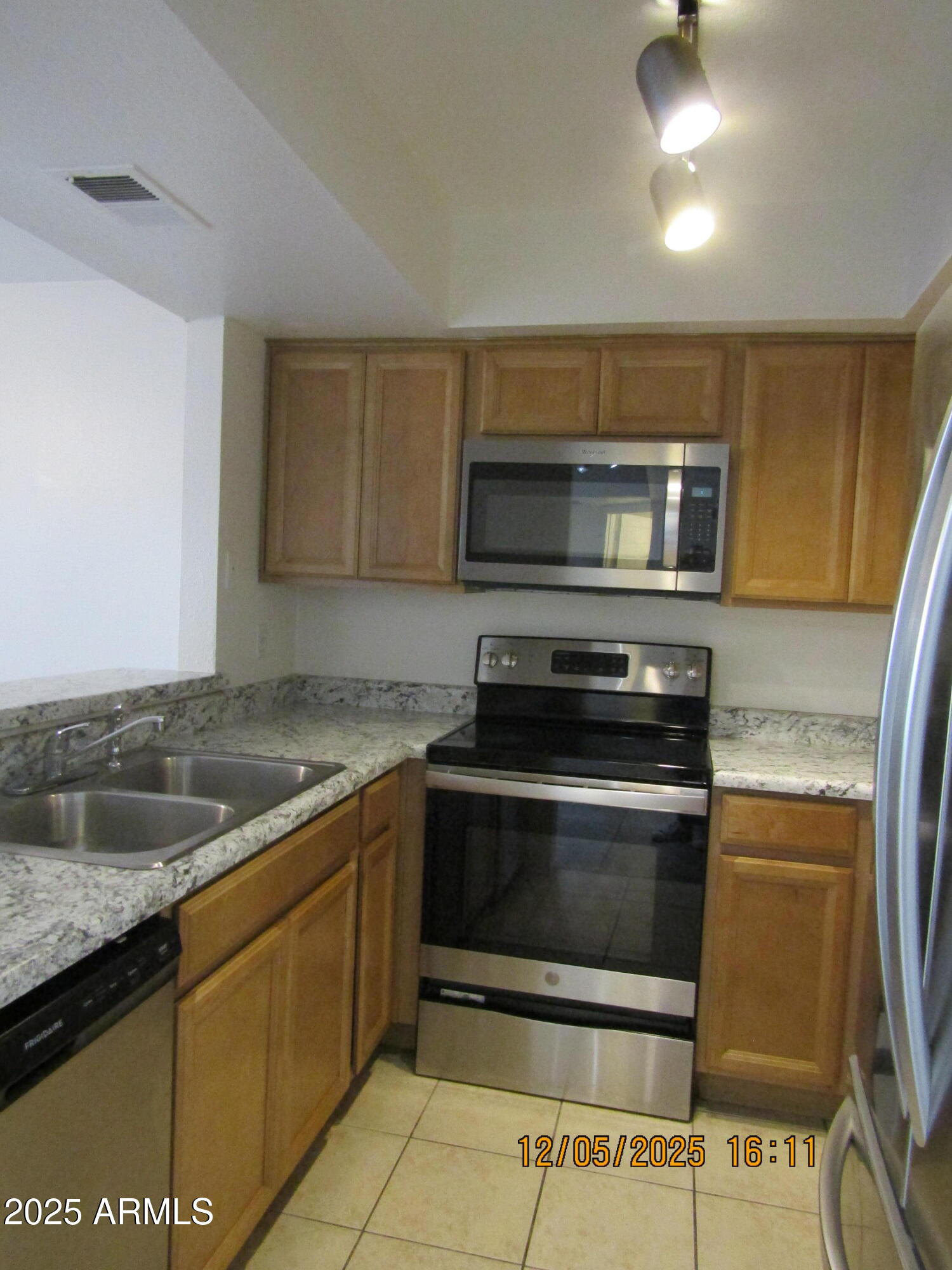 1331 West Baseline Road, Unit 102 Mesa, AZ 85202 - Photo 5 of 13 a kitchen with a sink and a stove top oven
