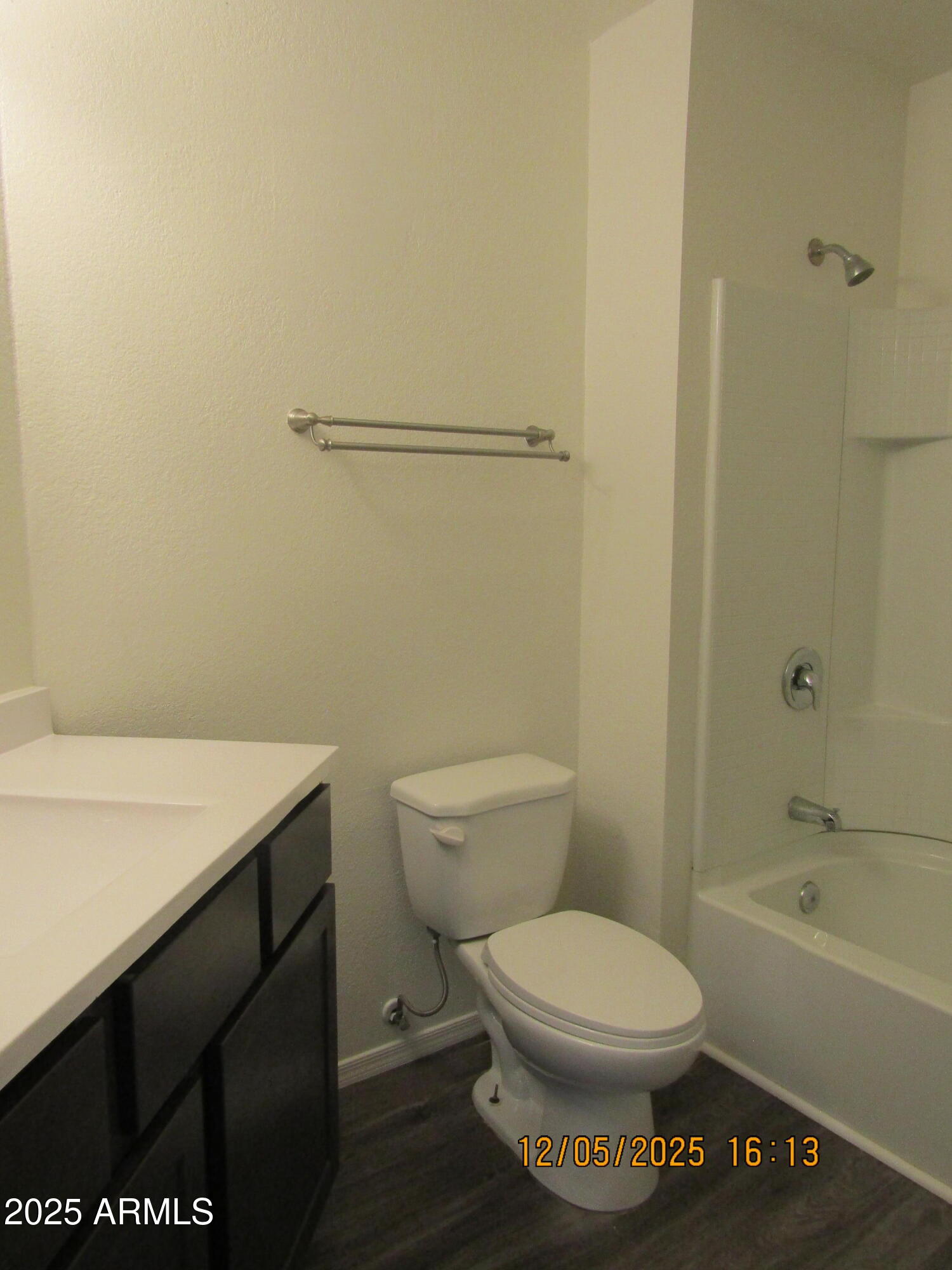 1331 West Baseline Road, Unit 102 Mesa, AZ 85202 - Photo 8 of 13 a bathroom with a toilet a sink and bathtub