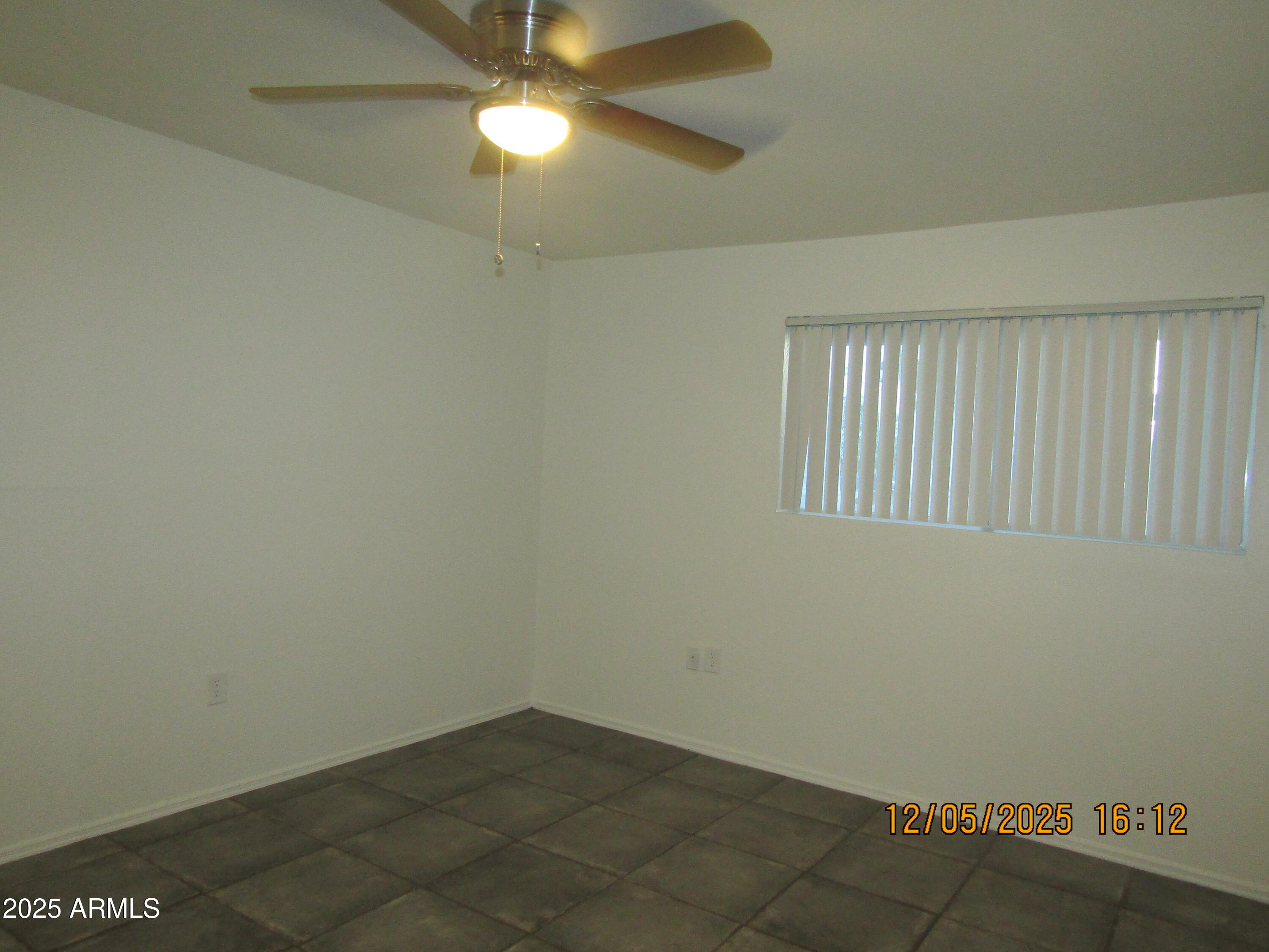 1331 West Baseline Road, Unit 102 Mesa, AZ 85202 - Photo 10 of 13 an empty room with a fan & a window