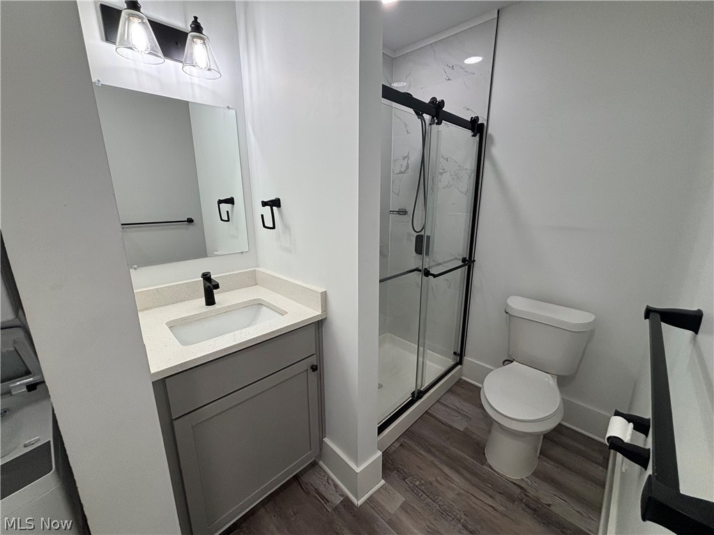 4115 Whitman Avenue, Unit UP Cleveland, OH 44113 - Photo 10 of 12 Full bath featuring a marble finish shower, vanity, and dark wood finished floors