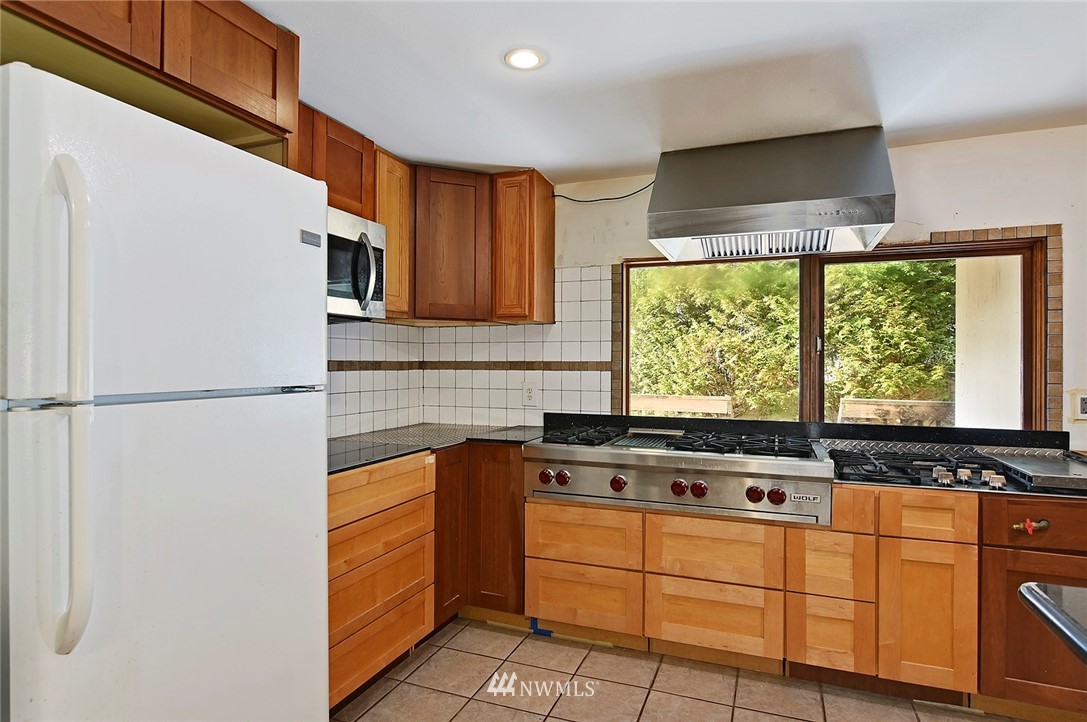 1000 Duchess Road Bothell, WA 98012 - Photo 14 of 35 a kitchen with stainless steel appliances a refrigerator sink and cabinets