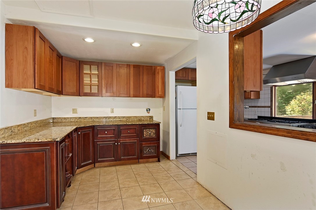 1000 Duchess Road Bothell, WA 98012 - Photo 15 of 35 a kitchen with stainless steel appliances granite countertop a refrigerator and a sink