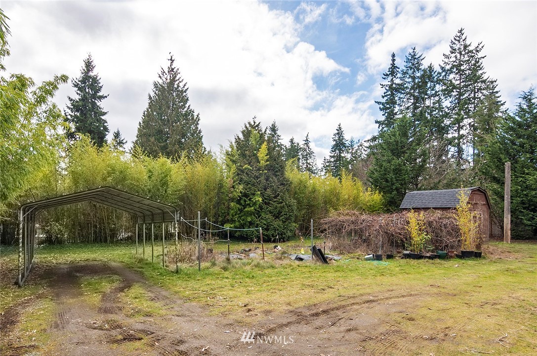 1000 Duchess Road Bothell, WA 98012 - Photo 24 of 35 a backyard of a house with trees and swing