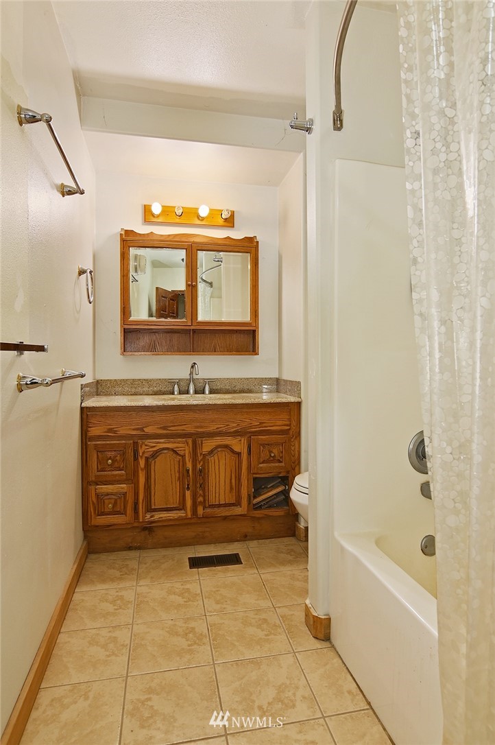 1000 Duchess Road Bothell, WA 98012 - Photo 32 of 35 a bathroom with a sink and a mirror