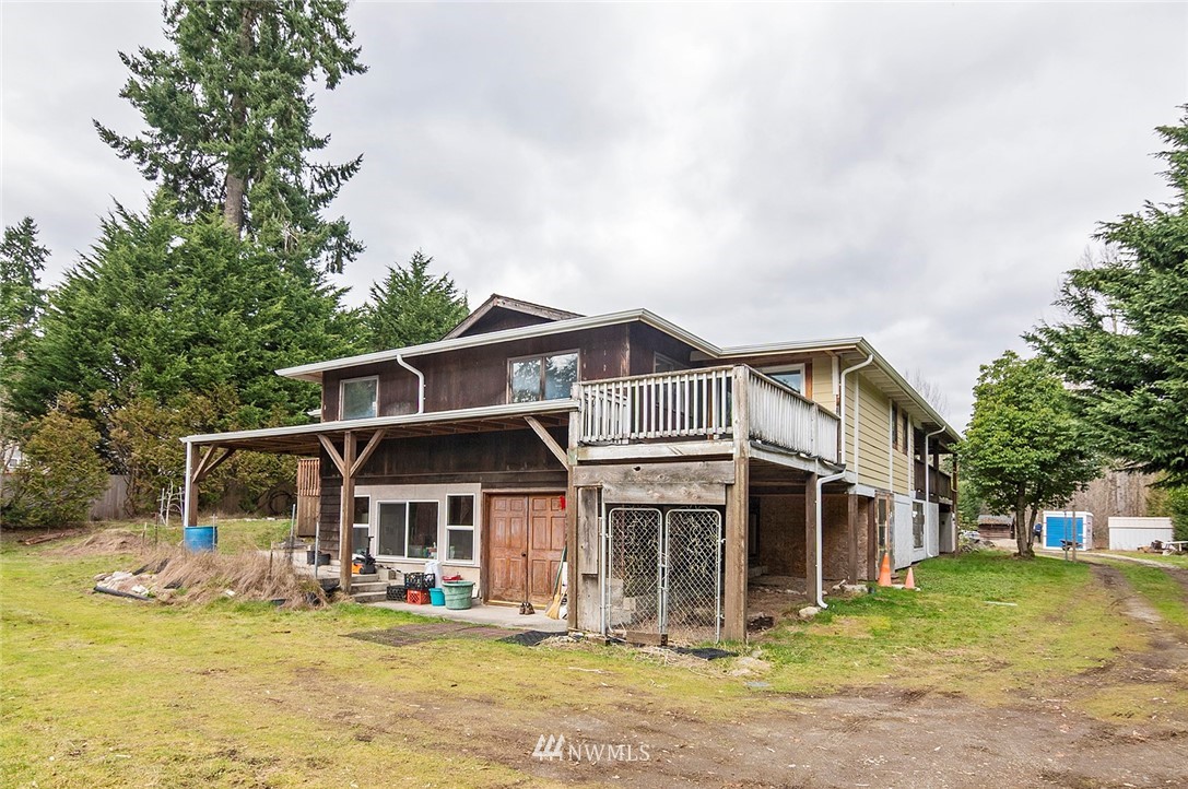 1000 Duchess Road Bothell, WA 98012 - Photo 6 of 35 a view of a white house with a swimming pool table and chairs