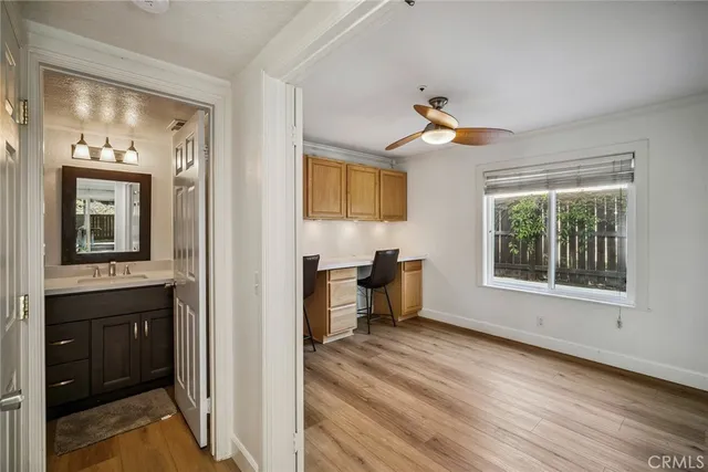 a view of a room with wooden floor table and chairs