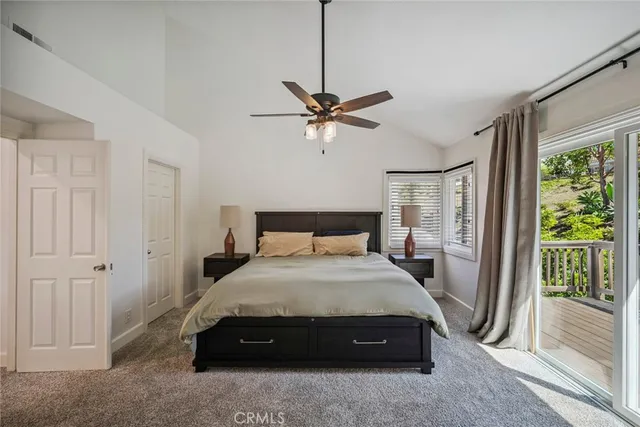 a view of a bedroom with furniture and a flat screen tv