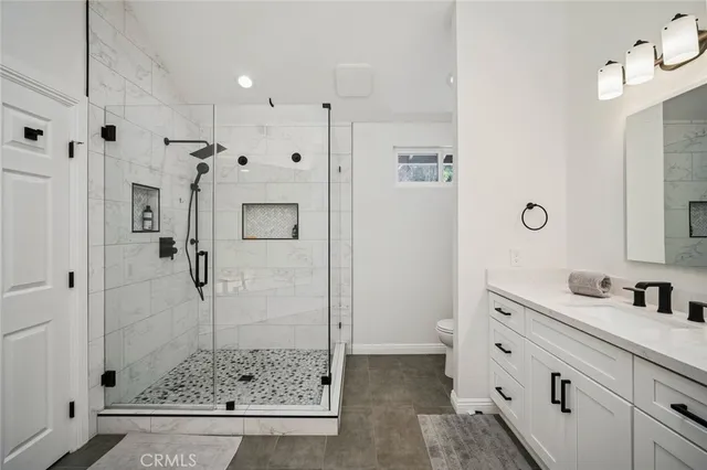 a bathroom with a double vanity sink and mirror