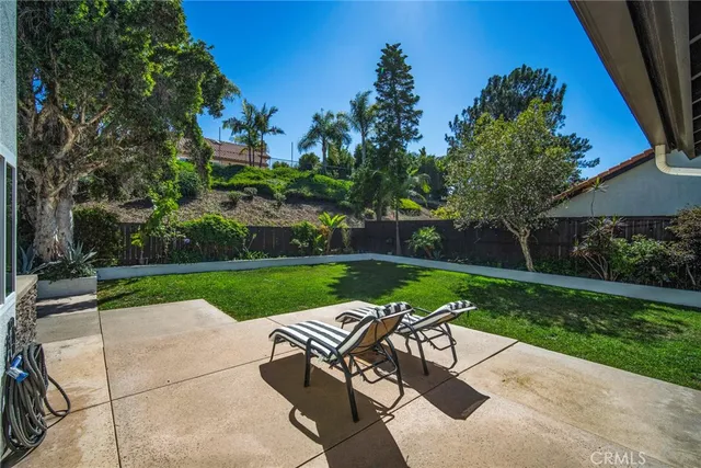 a roof deck with table and chairs potted plants and a barbeque