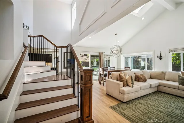 a living room with furniture and a chandelier