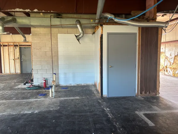a view of a hallway with wooden walls and windows