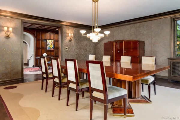 a view of a dining room with furniture and chandelier