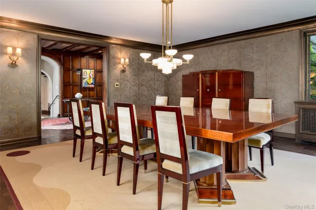 a view of a dining room with furniture and chandelier