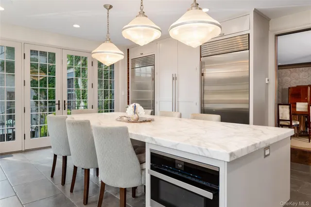 a dining table with chairs and window