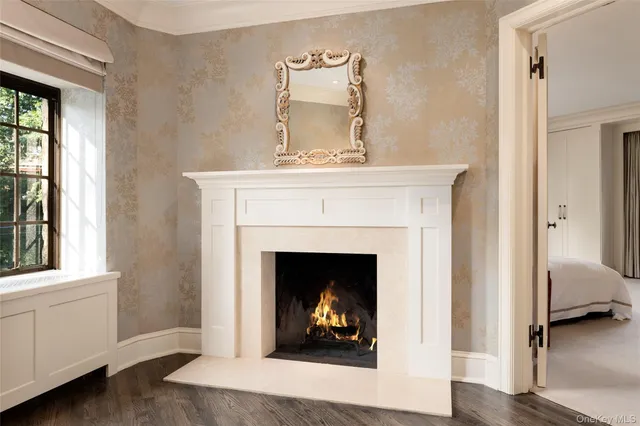 a living room with a fireplace and a wooden floor