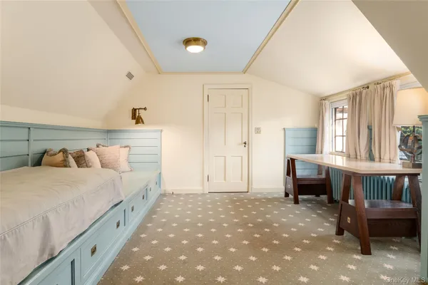 a spacious bedroom with a bed and a table