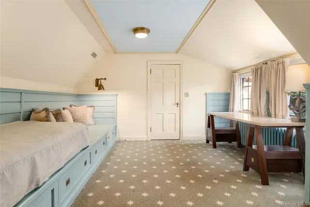 a spacious bedroom with a bed and a table