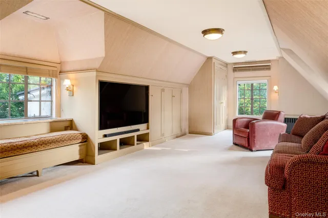 a living room with furniture window and flat screen tv