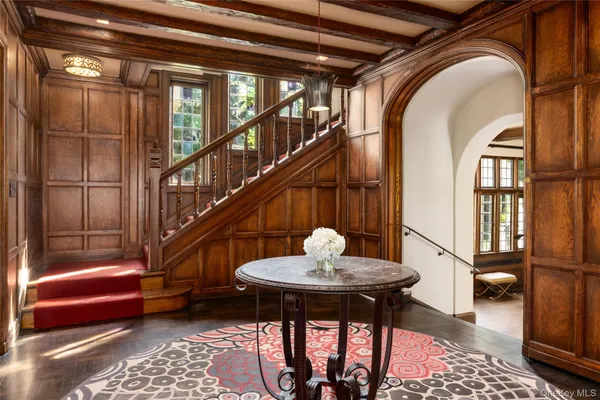 a view of entryway and hall with wooden floor