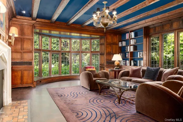 a living room with furniture and a floor to ceiling window