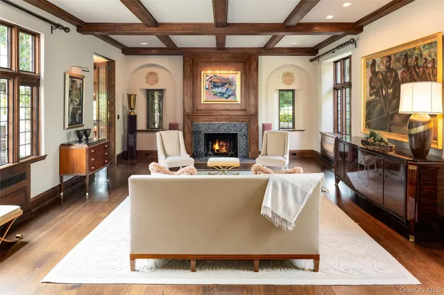 a living room with fireplace furniture and a table