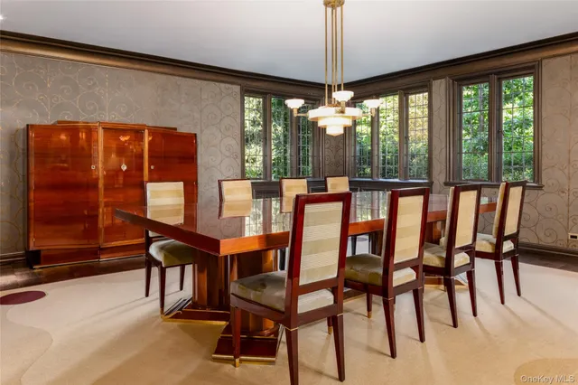 a dining room with furniture chandelier and glass door
