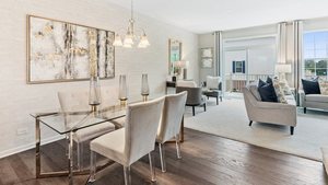 574 Wolverine Drive Aurora, IL 60502 - Photo 5 of 17 a view of a dining room with furniture a chandelier and wooden floor