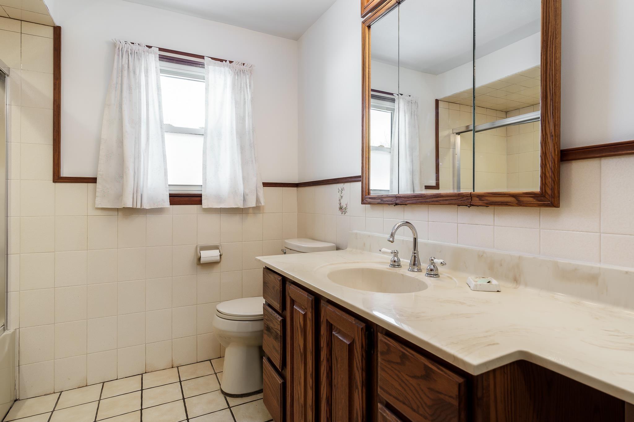 9189 Pomeroy Road Rockton, IL 61072 - Photo 15 of 34 a bathroom with a sink a toilet and a mirror