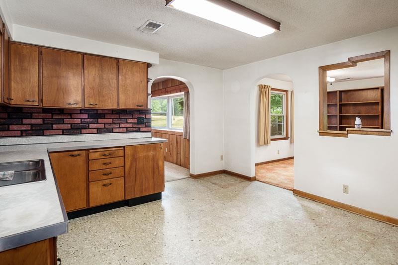 9189 Pomeroy Road Rockton, IL 61072 - Photo 7 of 34 a view of a kitchen with stainless steel appliances granite countertop a stove a sink and a microwave